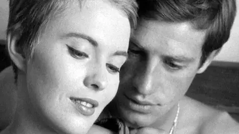 Headshots of a woman and a man, the protagonists, in close proximity