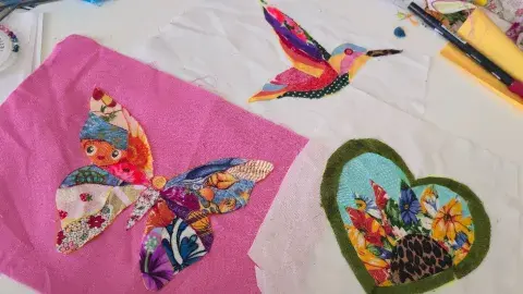 fabric scrap collage of a butterfly, bird, and heart 