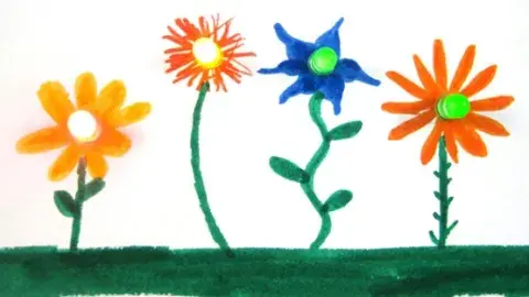 Hand drawn flowers with markers have LED lights with batteries attached to makes the flower centers glow.