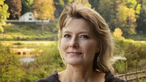 Jennifer Egan arms crossed in a black dress 