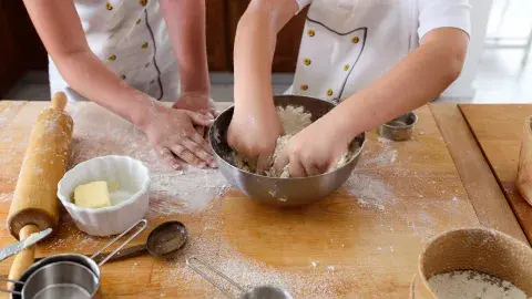 Two young people mix dough together
