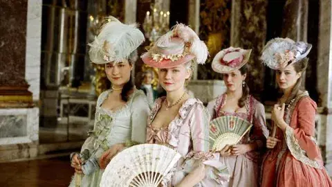 Four ladies dressed in beautiful, colorful French style dress
