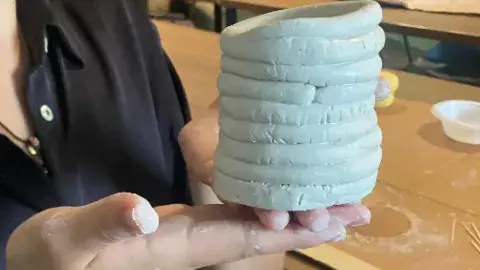 hands holding sculpture