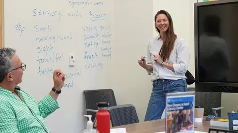 Instructor and students in a classroom.