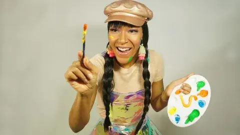 Snooknuk holding a paint palette and paintbrush