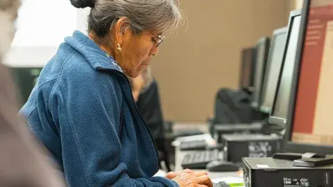 Adult woman looking at a computer screen