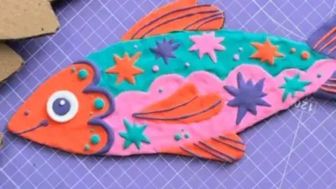 colorful clay fish on flat board