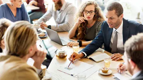people gathered around a table having a financial discussion