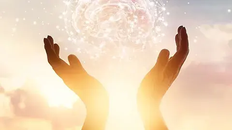 Sunlight through upraised hands.