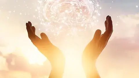 Sunlight through upraised hands.