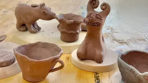 A handful of clay art pieces that are used for storytelling. 