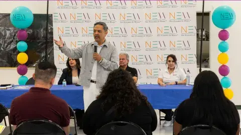 Person gives presentation to attendees