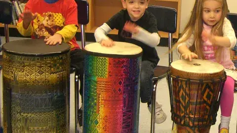 CHILDREN DRUMMING.