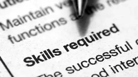 black and white text with a pen tip hovering over the words "Skills Required" in Bold print