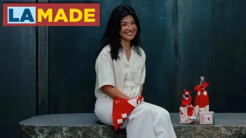 a person posing and smiling in front of a few wrapped items
