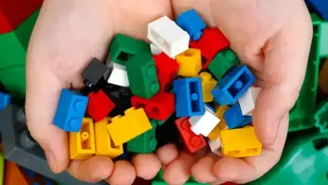 2 cupped hands holding legos