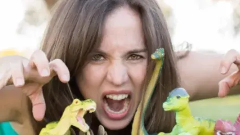 Woman acting out being a dinosaur