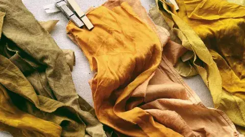 Three naturally dyed pieces of cloth of different shades. 