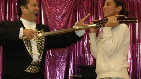 illusionist Allen Oshiro and a volunteer as they perform a magic trick.