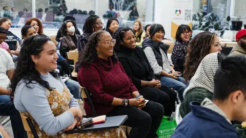 smiling women sitting in an audience