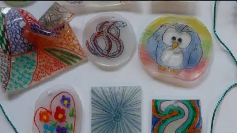 a number of shrinky dinks are laid out on a white surface