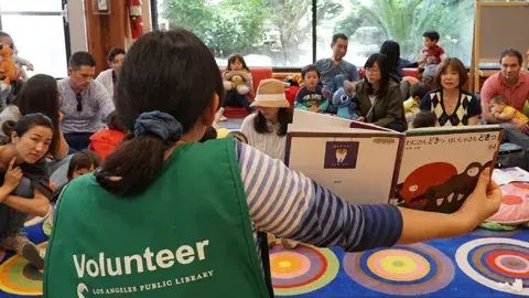 person reading to a group of kids