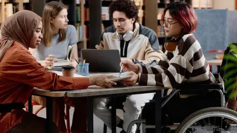 Four teens studying at a table