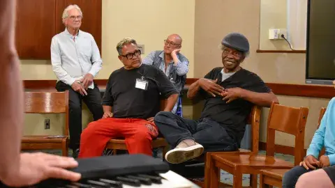 four people participating in a library program 