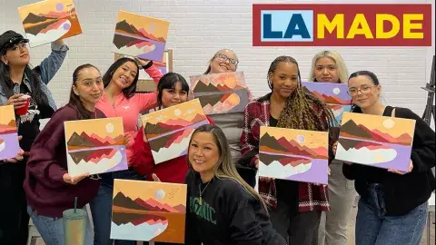 adults with paintings made in a class