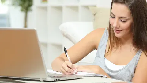 Woman writing on paper.