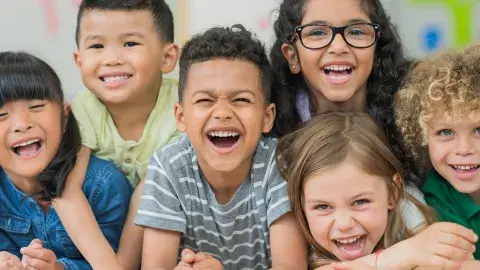 Six young children laughing.