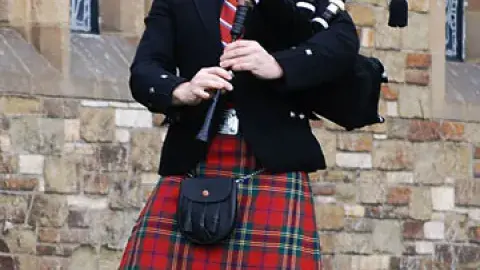 A man plays the bagpipes