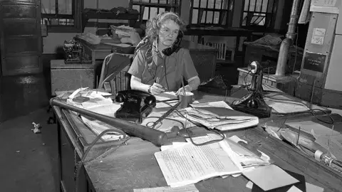 Agness "Aggie" Underwood at her desk in 1949