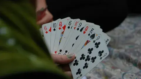 A person holding playing cards