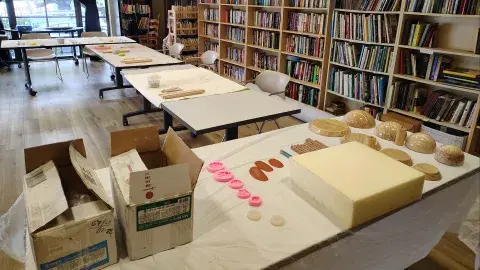 Setup for a ceramics program with clay and other ceramics tools on the tables 