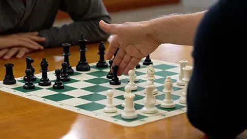 chess board with a hand pointing