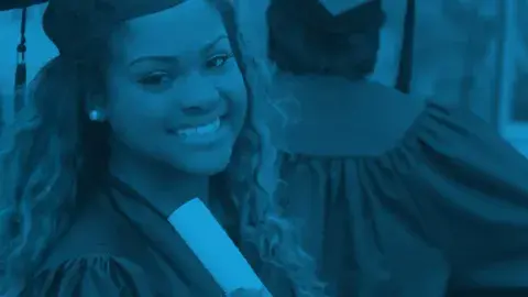 Teen graduate smiling in cap and gown.