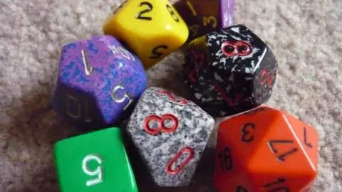 Group of orange, purple, red, green, and blue dice.