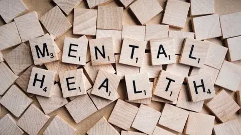 Scrabble game pieces spelling out "Mental Health"