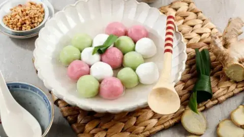 colorful chinese dessert dumplings with ingredients and utensils