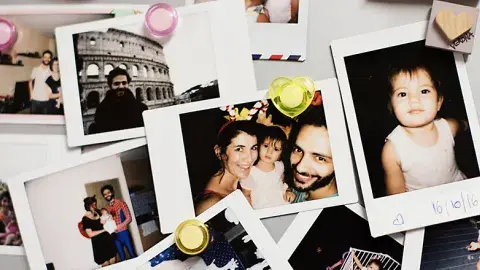 Collection of family pictures with small magnets in the corners.