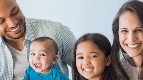 Mother, father and two children smiling