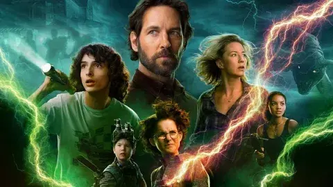 The cast of Ghostbusters afterlife pictured behind a field of lightning 