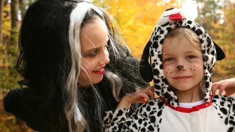 Halloween costumes, a witch and a spotted dog