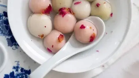 Colorful Tang Yuan, a Chinese dessert dumpling, in a white bowl