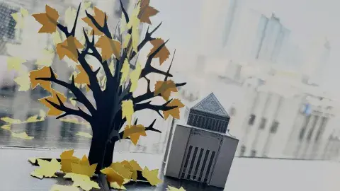 Paper skeleton tree against cityscape