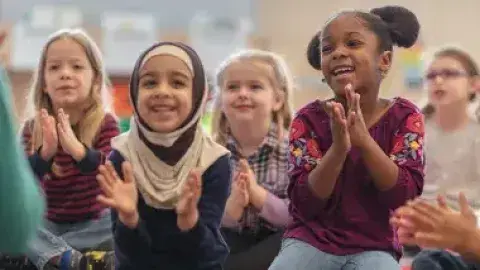 A group of children clapping