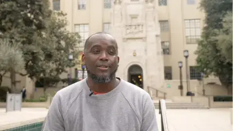 Kwasi Boyd-Bouldin in front of the Central Library
