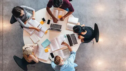 Students around a table.