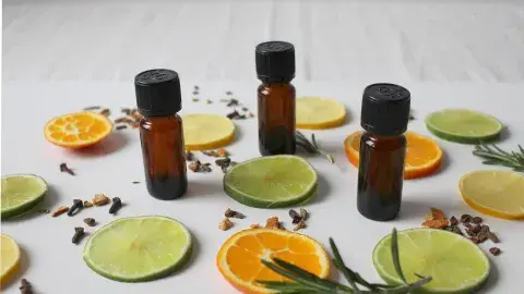 Array of beauty vials interspersed with orange and lemon slices